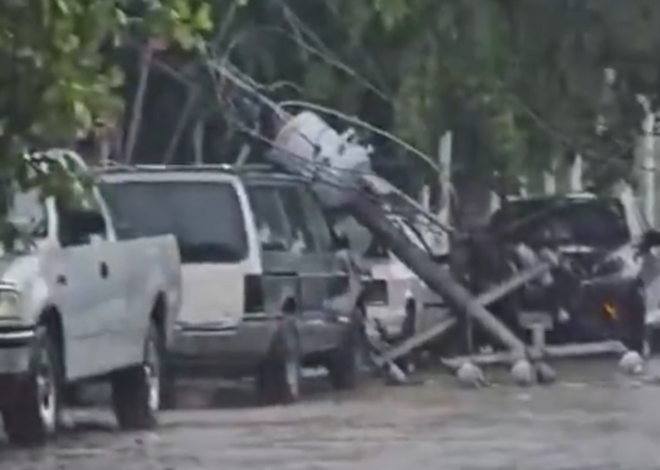 Lluvias derriban poste de CFE sobre vehículos en Cancún